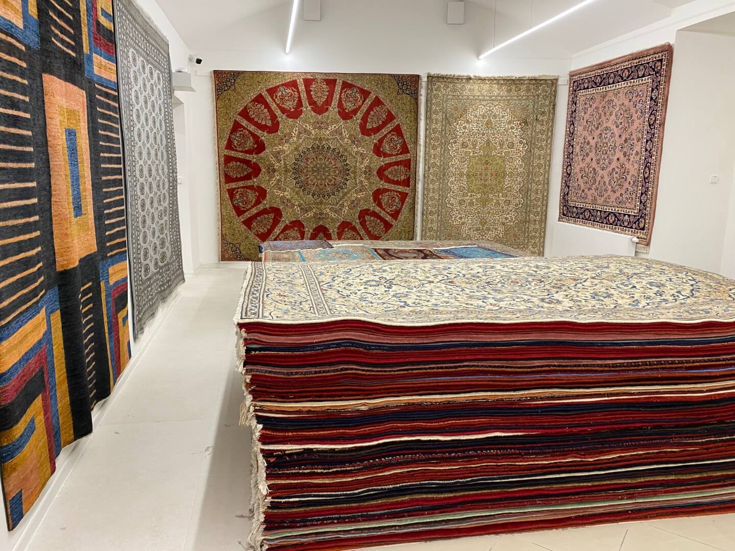 Many styles, colours and sizes of hand-knotted rugs together in one showroom